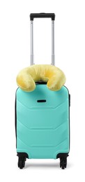 Photo of Soft travel pillow on turquoise suitcase isolated on white