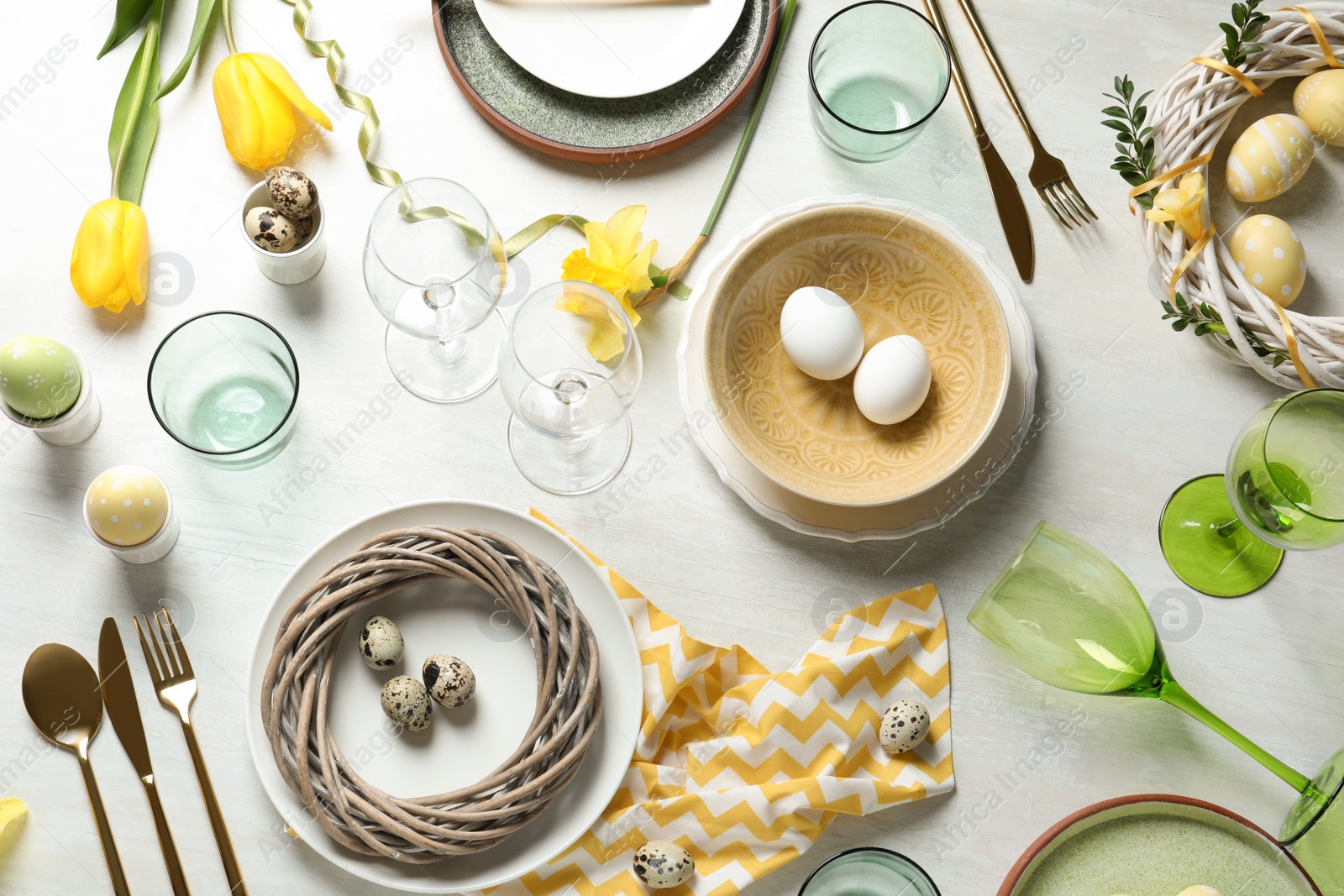 Photo of Festive Easter table setting with eggs on wooden background, top view