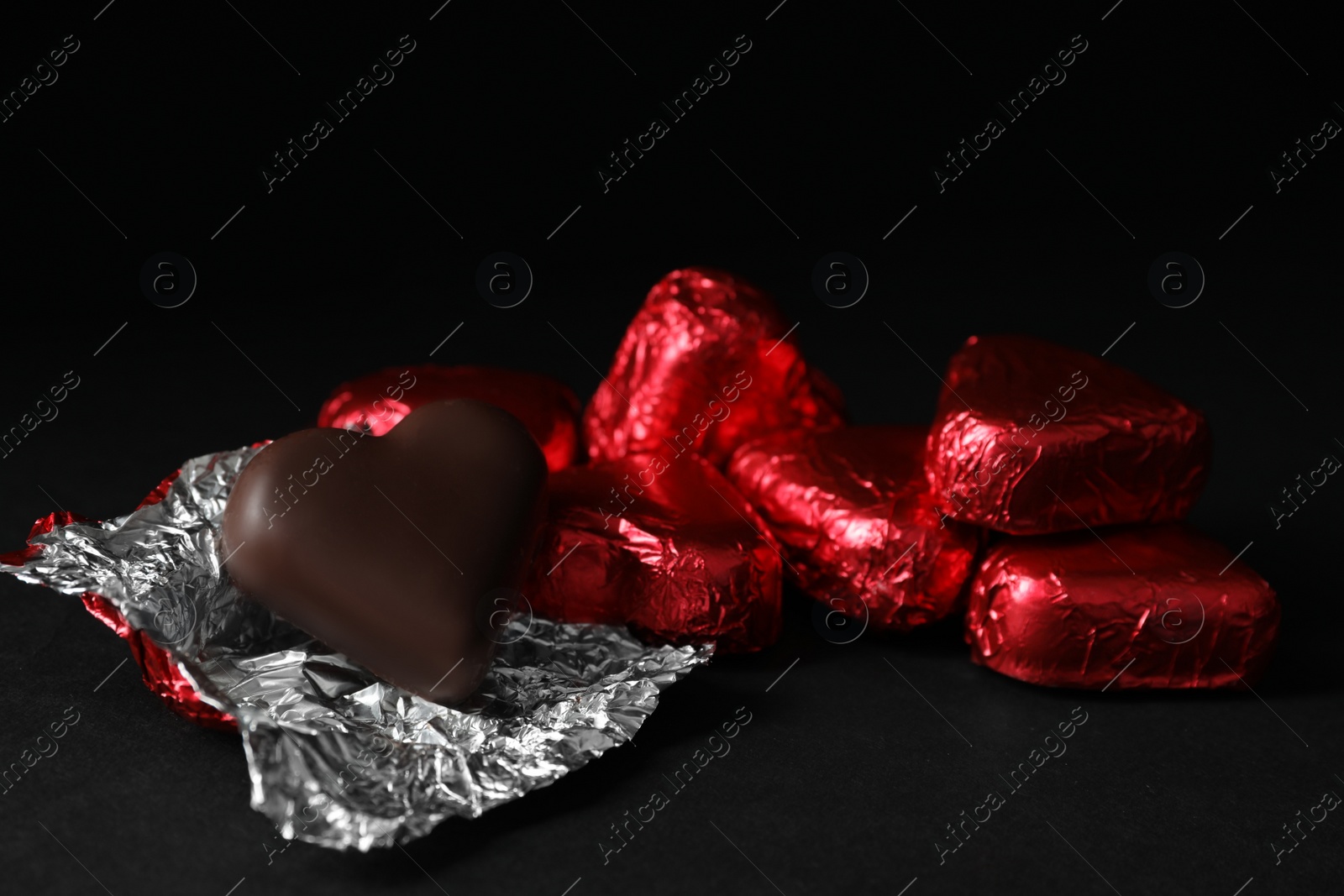 Photo of Beautiful heart shaped chocolate candies on wooden table