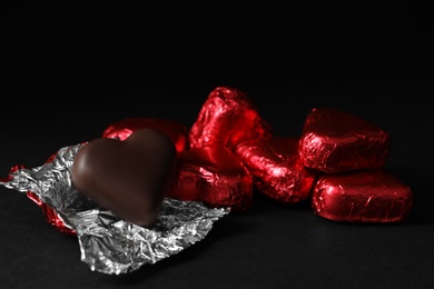 Photo of Beautiful heart shaped chocolate candies on wooden table