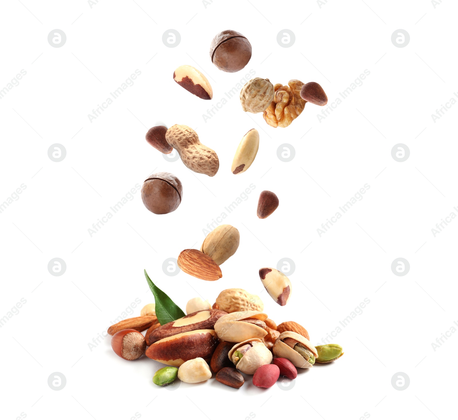 Image of Different nuts falling into pile on white background 