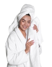 Photo of Beautiful young woman wearing bathrobe with towels against white background