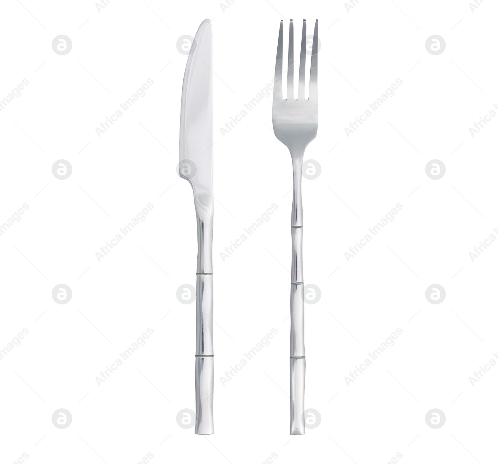 Image of Shiny silver knife and fork on white background, top view