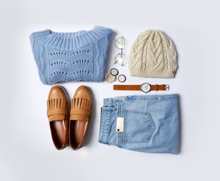 Stylish female autumn outfit and accessories on white background, flat lay. Trendy warm clothes