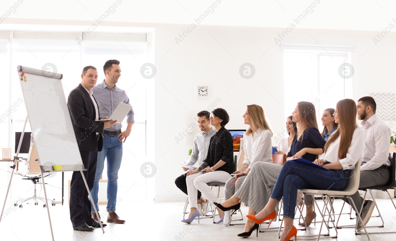 Photo of Business trainers giving lecture in office