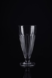 Photo of Clean empty cocktail glass on black background