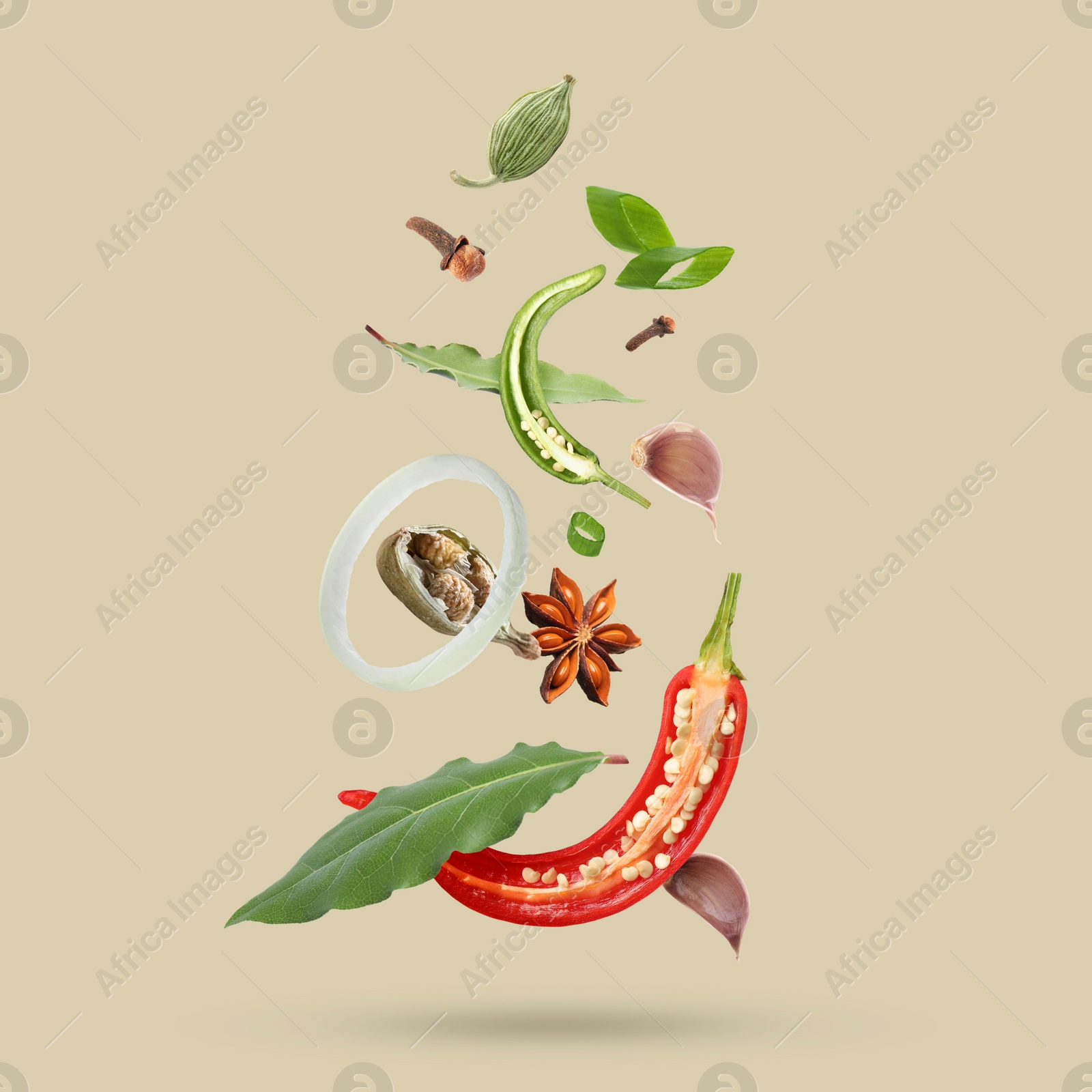 Image of Different spices falling on dark beige background