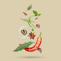 Image of Different spices falling on dark beige background