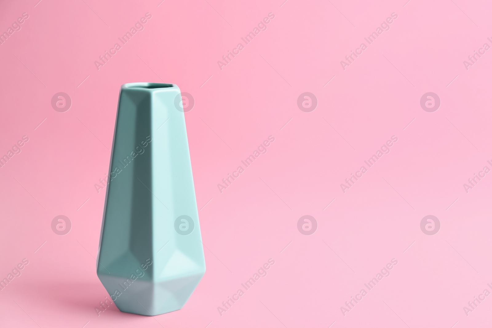 Photo of Stylish empty ceramic vase on pink background, space for text