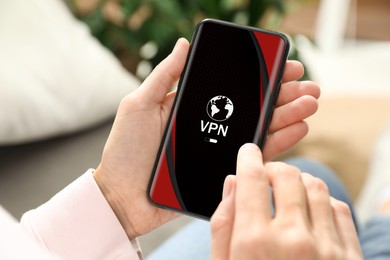 Image of Woman using smartphone with switched on VPN indoors, closeup