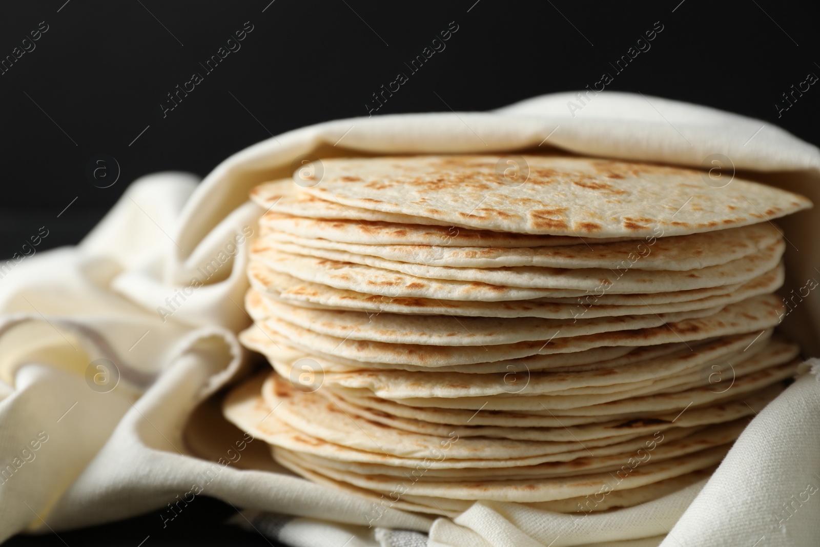 Photo of Stack of tasty homemade tortillas on table