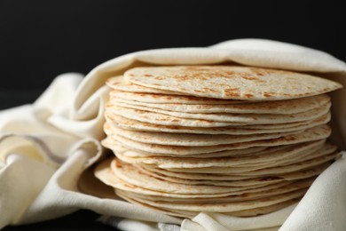 Photo of Stack of tasty homemade tortillas on table