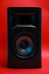 One wooden sound speaker on red background