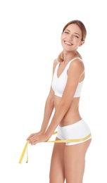Photo of Happy slim woman in underwear with measuring tape on white background. Positive weight loss diet results