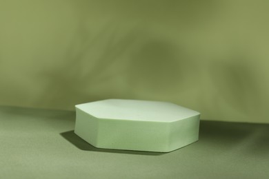 Presentation of product. Podium and shadows on light green background. Space for text