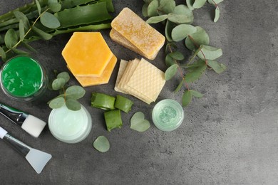 Photo of Homemade cosmetic products, tools and fresh ingredients on black table, flat lay. Space for text