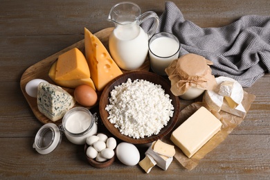 Different delicious dairy products on wooden table