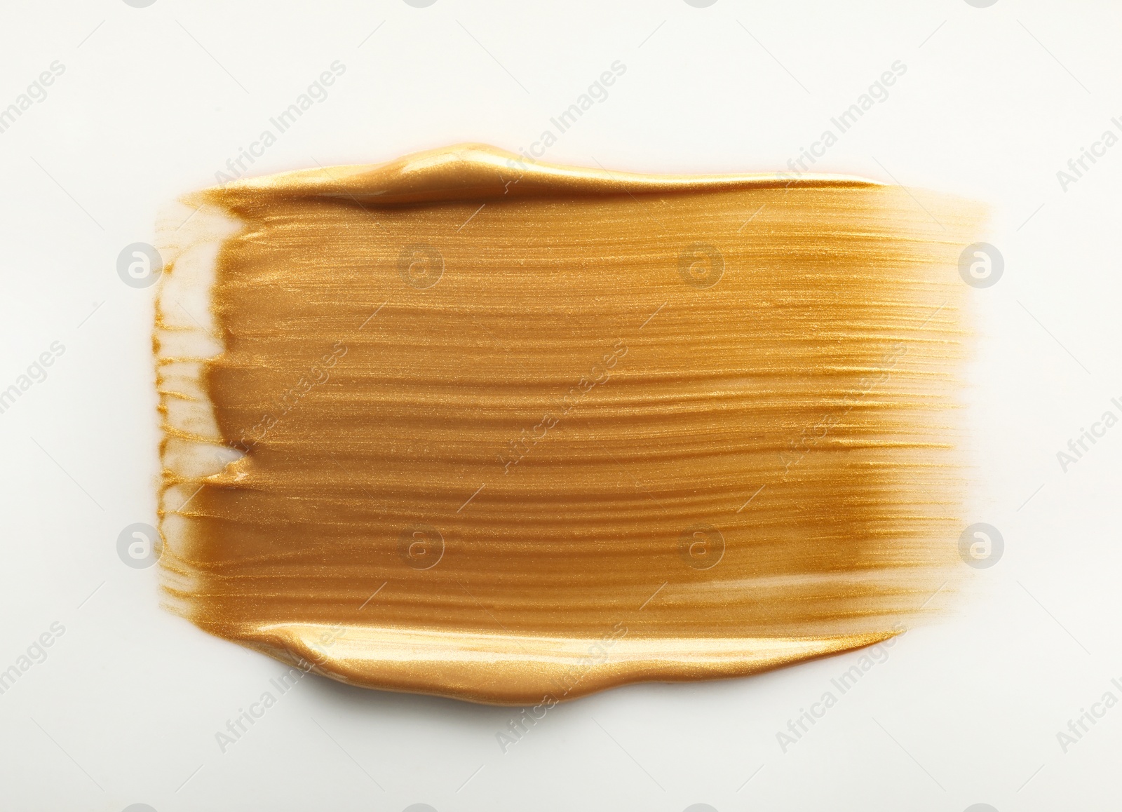 Photo of Stroke of gold paint isolated on white, top view