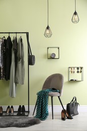 Modern dressing room interior with clothing rack and chair