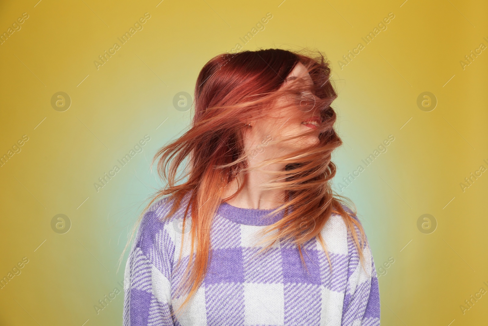 Photo of Young woman with bright dyed hair on yellow background