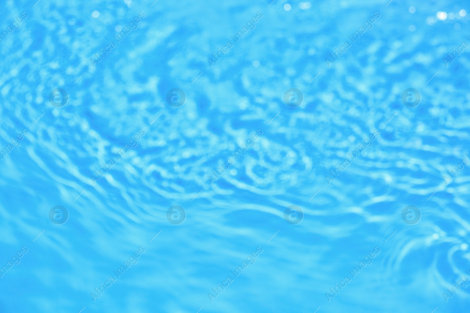 Photo of Blurred view of swimming pool with clean blue water on sunny day