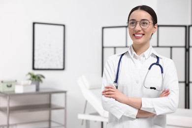 Photo of Medical consultant with glasses and stethoscope in clinic, space for text