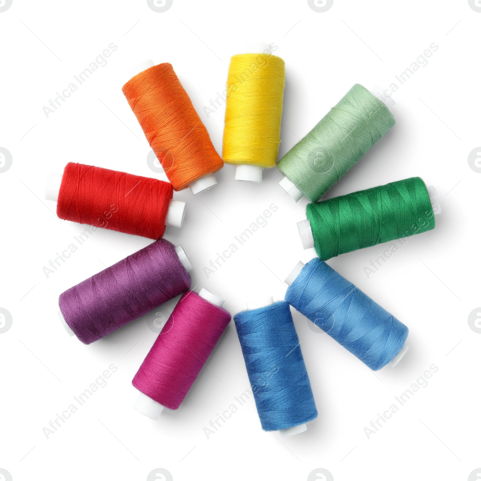 Photo of Frame of different colorful sewing threads on white background, top view. Space for text