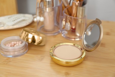 Set of makeup products on wooden dressing table