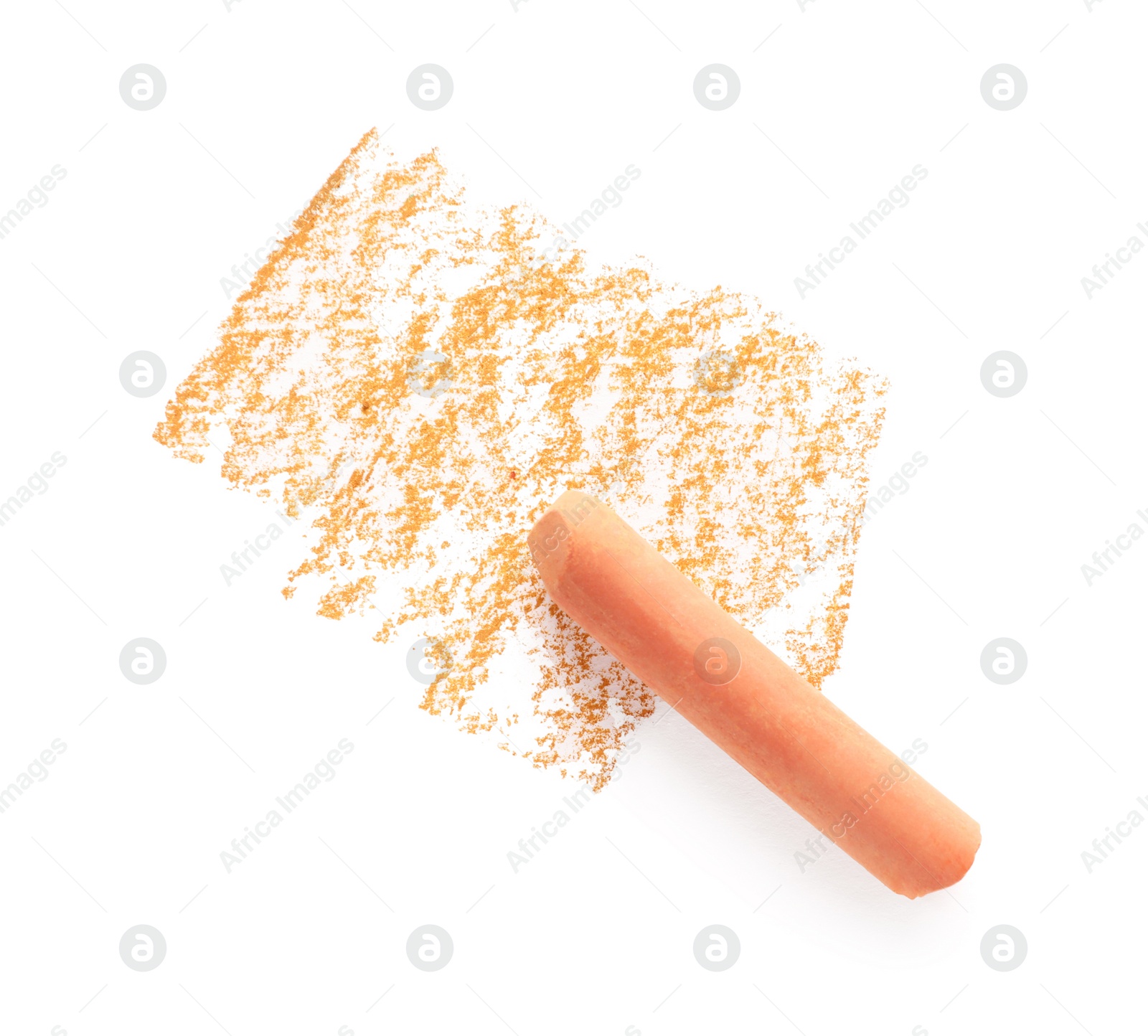 Photo of Orange pastel chalk on sheet of paper with scribble, top view. Drawing material