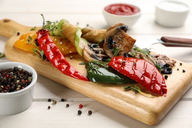 Photo of Delicious grilled vegetables served on white wooden table, closeup