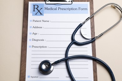Photo of Clipboard with medical prescription form and stethoscope on beige background