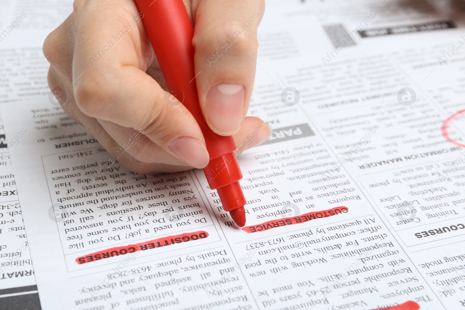 Photo of Woman marking advertisement in newspaper, closeup. Job search concept