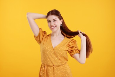 Photo of Portrait of smiling woman on yellow background