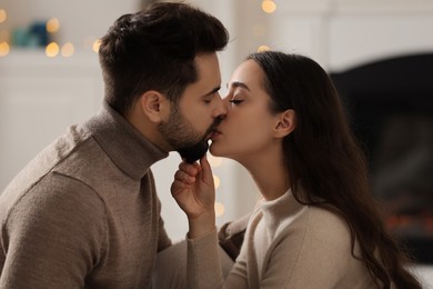 Photo of Passionate young couple kissing at home. Romantic date