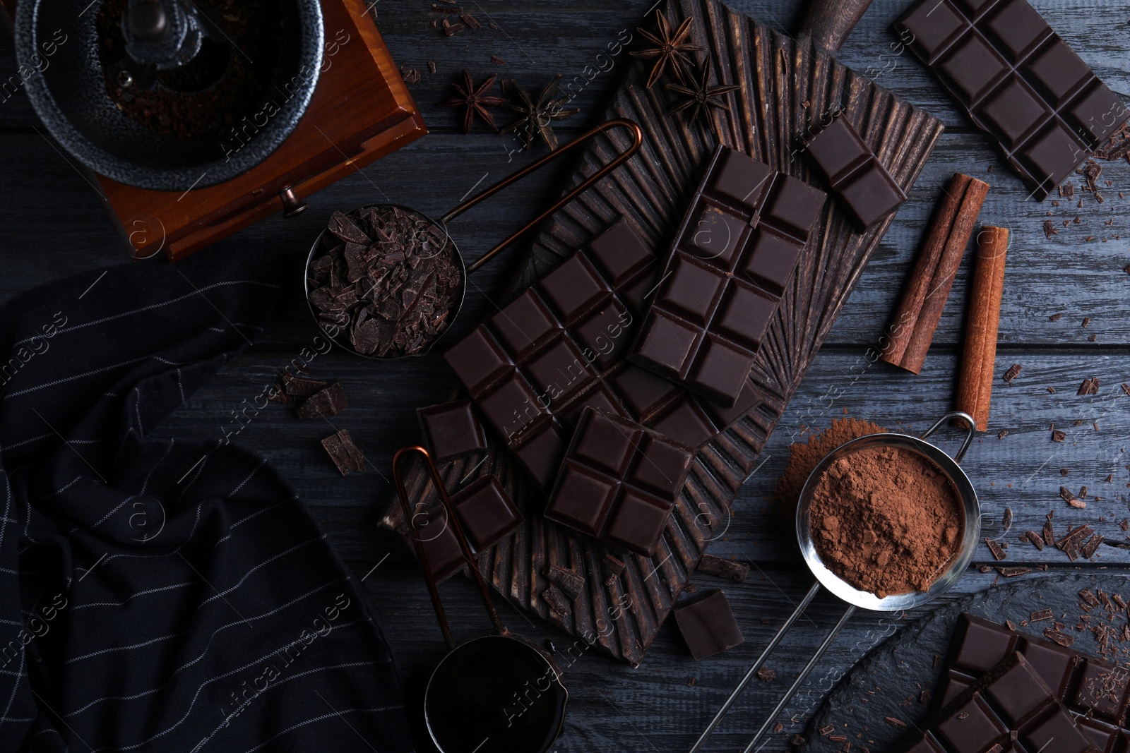 Photo of Flat lay composition with dark chocolate on black wooden table