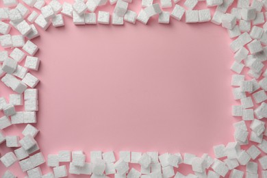 Photo of Frame made of styrofoam cubes on pink background, flat lay. Space for text