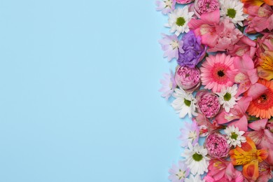 Photo of Flat lay composition with different beautiful flowers on light blue background, space for text