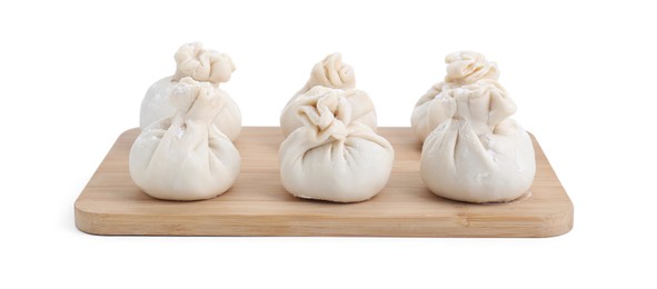 Wooden board with uncooked khinkali (dumplings) isolated on white. Georgian cuisine