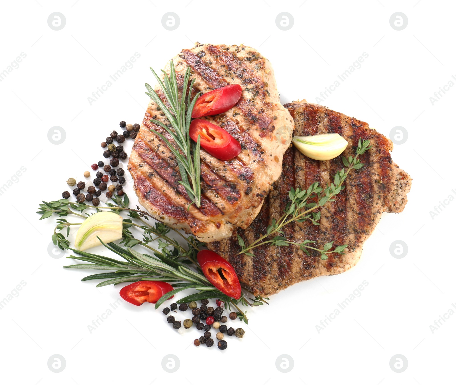 Photo of Delicious grilled pork steaks and spices on white background, top view