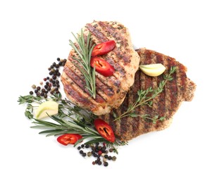 Photo of Delicious grilled pork steaks and spices on white background, top view