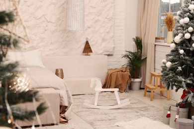 Photo of Bedroom interior with Christmas tree and festive decor