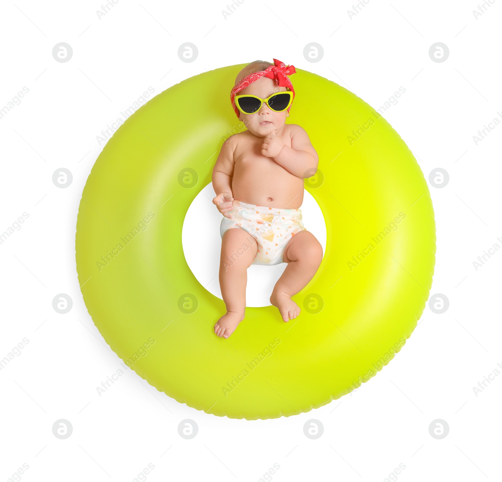 Photo of Cute little baby in sunglasses with inflatable ring on white background, top view