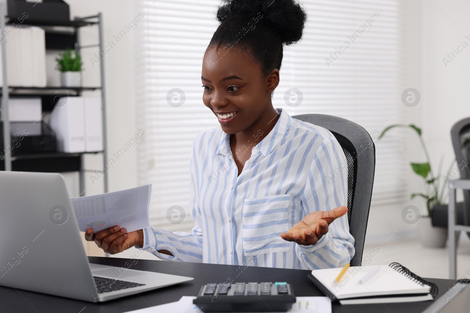 Photo of Professional accountant having video chat via computer at desk in office