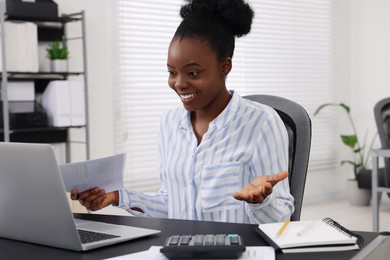 Photo of Professional accountant having video chat via computer at desk in office