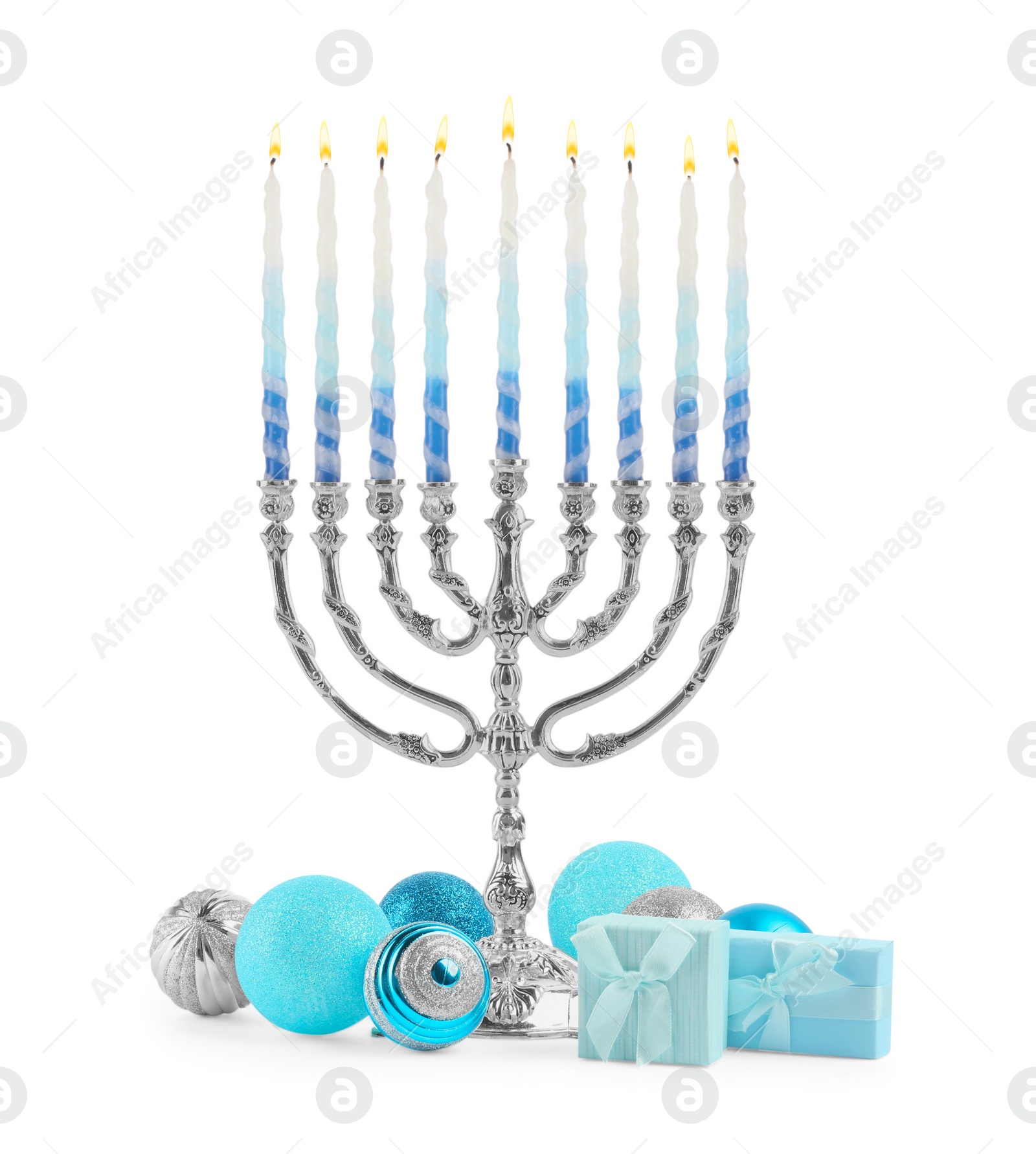 Photo of Hanukkah celebration. Menorah with colorful candles, festive baubles and gift boxes isolated on white