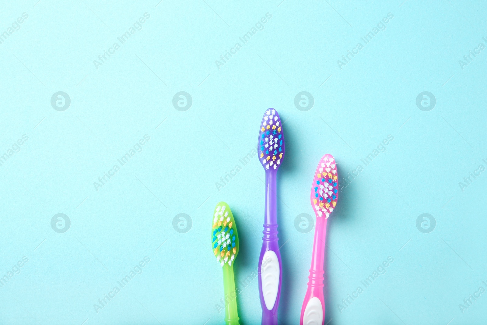 Photo of Flat lay composition with manual toothbrushes on color background