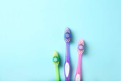 Flat lay composition with manual toothbrushes on color background