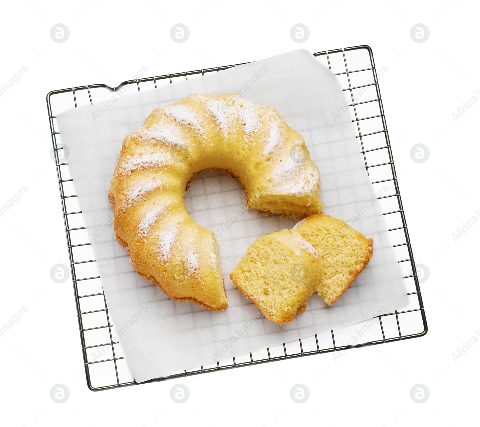 Photo of Cooling rack with freshly baked sponge cake isolated on white, top view