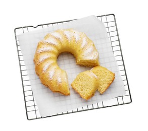 Photo of Cooling rack with freshly baked sponge cake isolated on white, top view
