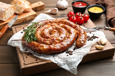 Photo of Delicious homemade sausage with spices served on wooden table